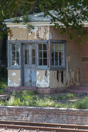 A close up view of a old abandoned building at a railway stationの写真素材