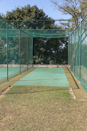 A close up view of a grass practice cricket netsの写真素材