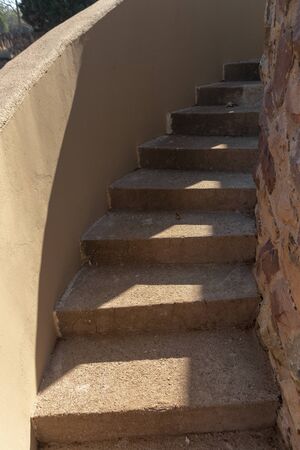 A close up view of a flight of stone stairs leading up to the roofの写真素材