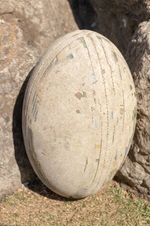 A close up front view of rugby ball on a green grass backgroundの写真素材