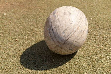 A close up front view of rugby ball on a green grass backgroundの写真素材