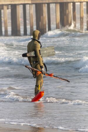 A close up view of a scuba diver waiting to enter the oceanの写真素材