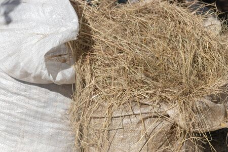 A close up view of hay in white plastic bagsの写真素材