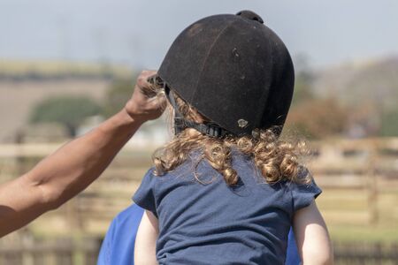 A close up view of a little girl ridingの写真素材