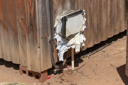 A close up view of an electrical box that has been covered and tape and plastic bagsの写真素材