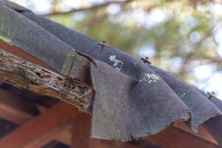 A close up view of a damaged roof covering a outside shelterの写真素材