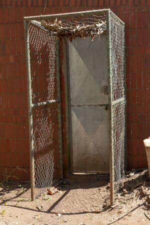 A close up view of a metal door leading into an enclosed areaの写真素材
