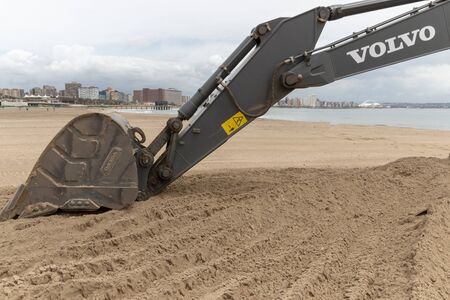 A close up view of a volvo grader digging up sand on Durban beachのeditorial素材