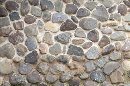 A close up view of a stone and concrete wall の写真素材