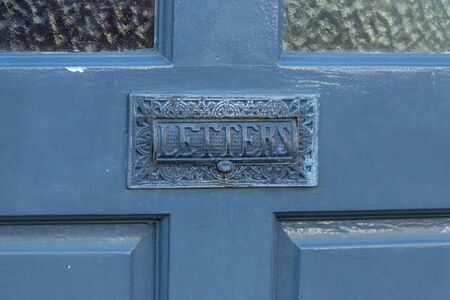 a close up view of a front door with the letter box on the frontの写真素材