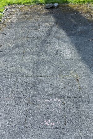 a close up view of a warm out hop skotch squares in a open public parkの写真素材