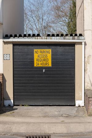 Bristol-March 2020-England-a close up view of a no entry and no parking sign on a garage door の写真素材