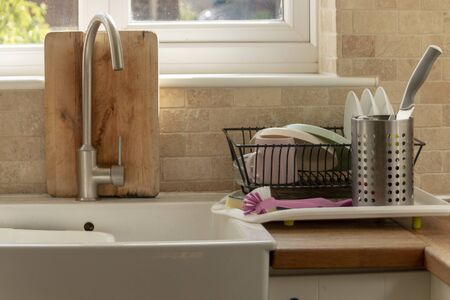 a close up view of clean dishing place in the drying rack in a open plan kitchen 
