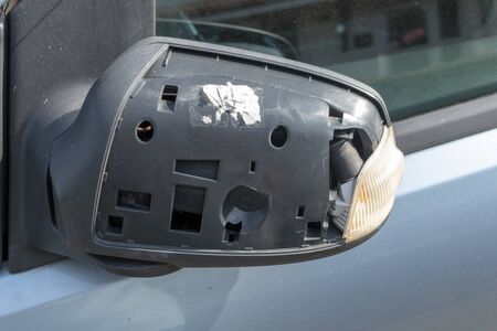 a close up view of a car side mirror that has been damaged の写真素材
