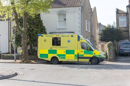 Bristol-April-2020-England- a close up view of a yellow ambulance waiting outside a home in fishponds for a sick patient の写真素材