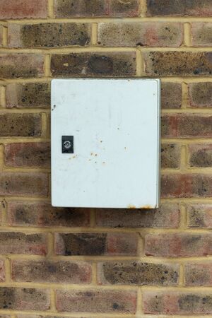 a close up view of a locked outside box that is attached to the wall outside a supermaketの写真素材