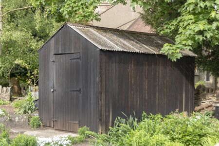 a close up view of a outside wooden shed in the back garden の写真素材