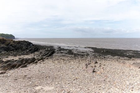 Bristol-May-2020-England-the view of the river and sea in clevedon with the rocks and thick mud leading to the waters edgeの写真素材