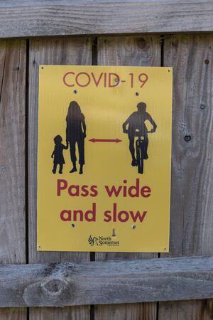 a close up view of a COVID-19 sign warning people of the two meter ruleの写真素材