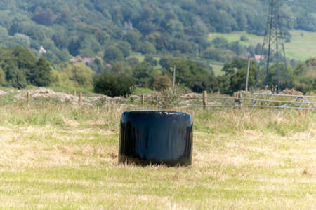 a close up view of hay bails that have been coveered in black plastic to protect them from the...