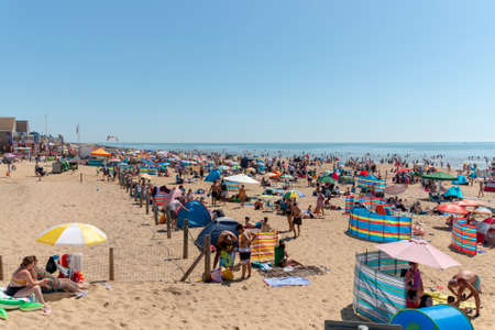 kent-August-2020-England- a view of a packed camber beach on a very hot summers day in kent, englandのeditorial素材