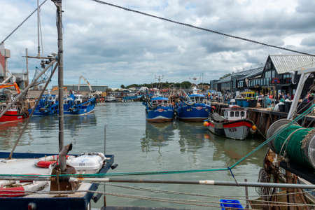 A close up view of fishing boats in a closed off habourの写真素材