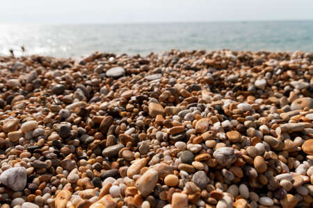 A close up view of the different pebbles on the beach at blackpool sands.の写真素材