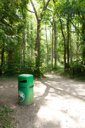A view of a eviromentally friendly rubbish bin in a open public forestの写真素材