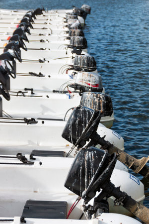 A line of speed boats at a dock awaiting to be sent out on the lakeの写真素材