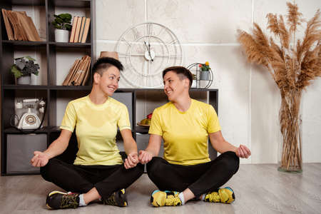 Two cute girls go in for sports together at home. Healthy lifestyle of two women.