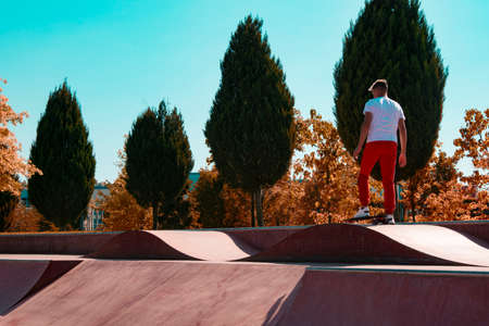 Skateboarder in sportswear doing a warm-up on a skatepark.の写真素材