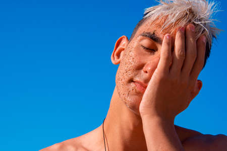 Summer and vacation. An attractive guy is resting at the sea.の写真素材