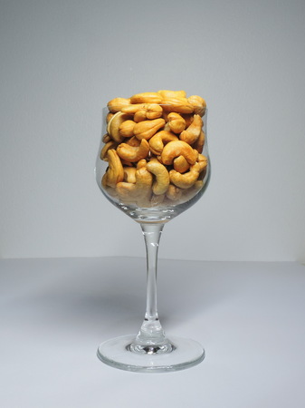 Cashew nuts in a wine glass.の写真素材