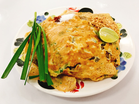 Thai stir fried rice noodles or Pad thai with prawn wrapped in egg.