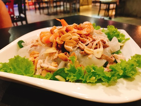 A dish of spicy wide rice noodles salad in Thailand.