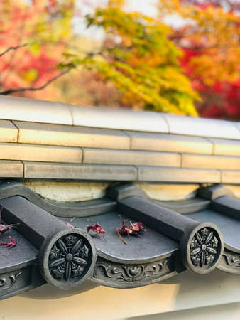 Kyoto, Japan - December 1, 2019: Roof tile art of Eikando Zenrinji Temple. The temple has a long history and there are a variety of buildings and a pond garden that very famous for its autumn colors.のeditorial素材