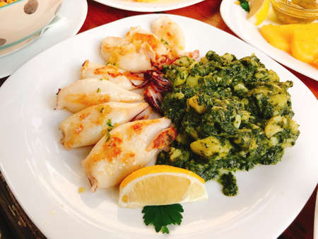 Grilled squids with chard and potatoes in Piran, Slovenia.の写真素材