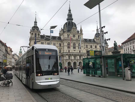 Graz, Austria - November 9, 2018:  A Cityrunner tram passes through Rathaus (town hall) in the heart of Graz's old town in Austria.