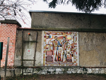 Graz, Austria - November 9, 2018:  Decorate the wall with mosaic tiles depicting people holding hands at the Schlossberg park in Graz, Austria.のeditorial素材