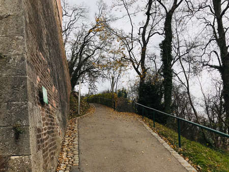 Graz, Austria - November 9, 2018:  Public park and part of enormous stone wall of the Schlossberg (Castle hill) in Graz, Austria.のeditorial素材