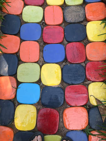 The walkway in the garden is paved with brightly colored glazed paving bricks.の写真素材