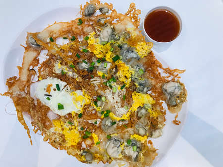 Crisp fried oysters pancake served with dip sauce in Thailand.の写真素材