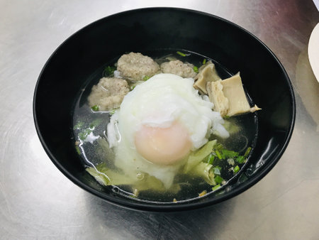 Chinese noodles soup with minced pork and poached egg in Thailand.