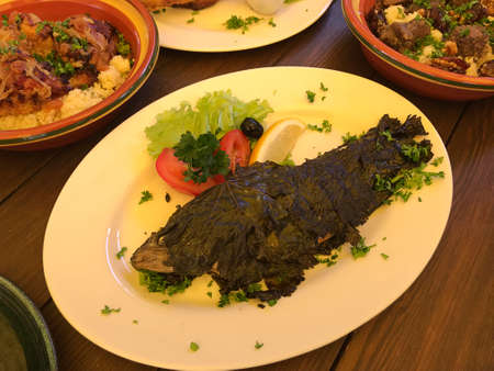 Trout fried in grape leaves in Trakai, Lithuania.の写真素材