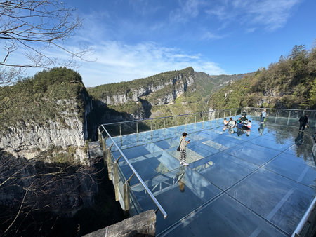 Chongqing, China - March 29 2024:  A glass viewing platform is 26m long glass deck extends 11m from the edge of a cliff and stands 280m above the karst valley in Chongqing, China.のeditorial素材