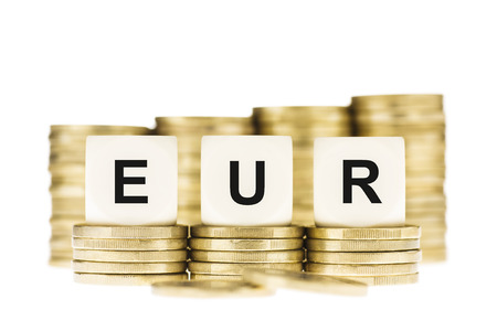 EUR  Euro Currency  on Gold Coin Stacks Isolated on Whiteの写真素材