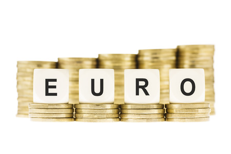 Word EURO  European Currency  on Gold Coin Stacks Isolated on Whiteの写真素材