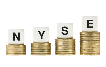 NYSE  New York Stock Exchange  Letters on Gold Coin Stacks Isolated on Whiteの写真素材