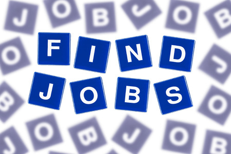Words FIND JOBS in Clear Focus Against Blurred Lettersの写真素材