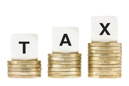 Word TAX on Gold Coin Stacks Isolated with White Backgroundの写真素材